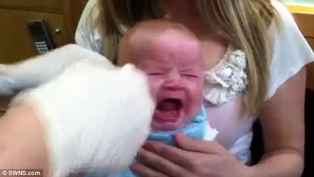 The video shows the baby screaming out in the video as she gets both of her ears pierced