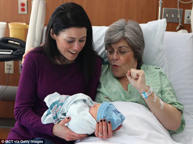 Family joy: Mrs Connell said that she and her mother - who became the oldest woman to give birth in Chicago - held hands as Finnean was delivered by cesarean section