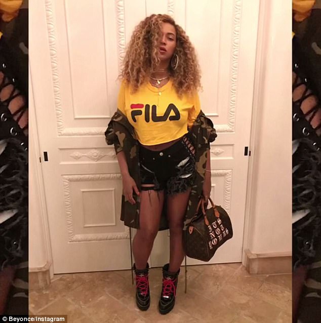 Flattering: Scenes also show the Crazy in Love singer modeling her outfit for the night, which consisted of a yellow Fila t-shirt, ripped shorts and chunky boots