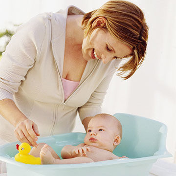 mother bathing baby