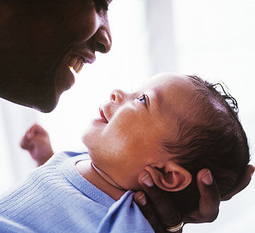 father holding baby