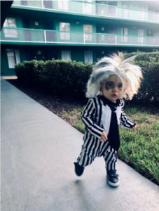 A little toddler is dressed as Beetlejuice