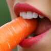 girl biting a carrot