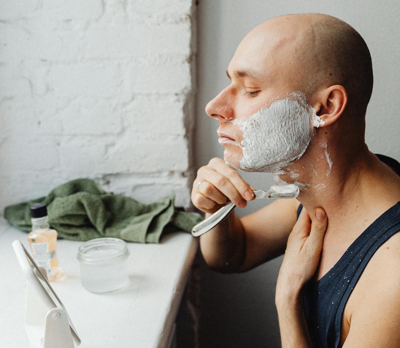 man shaving cream with shaver